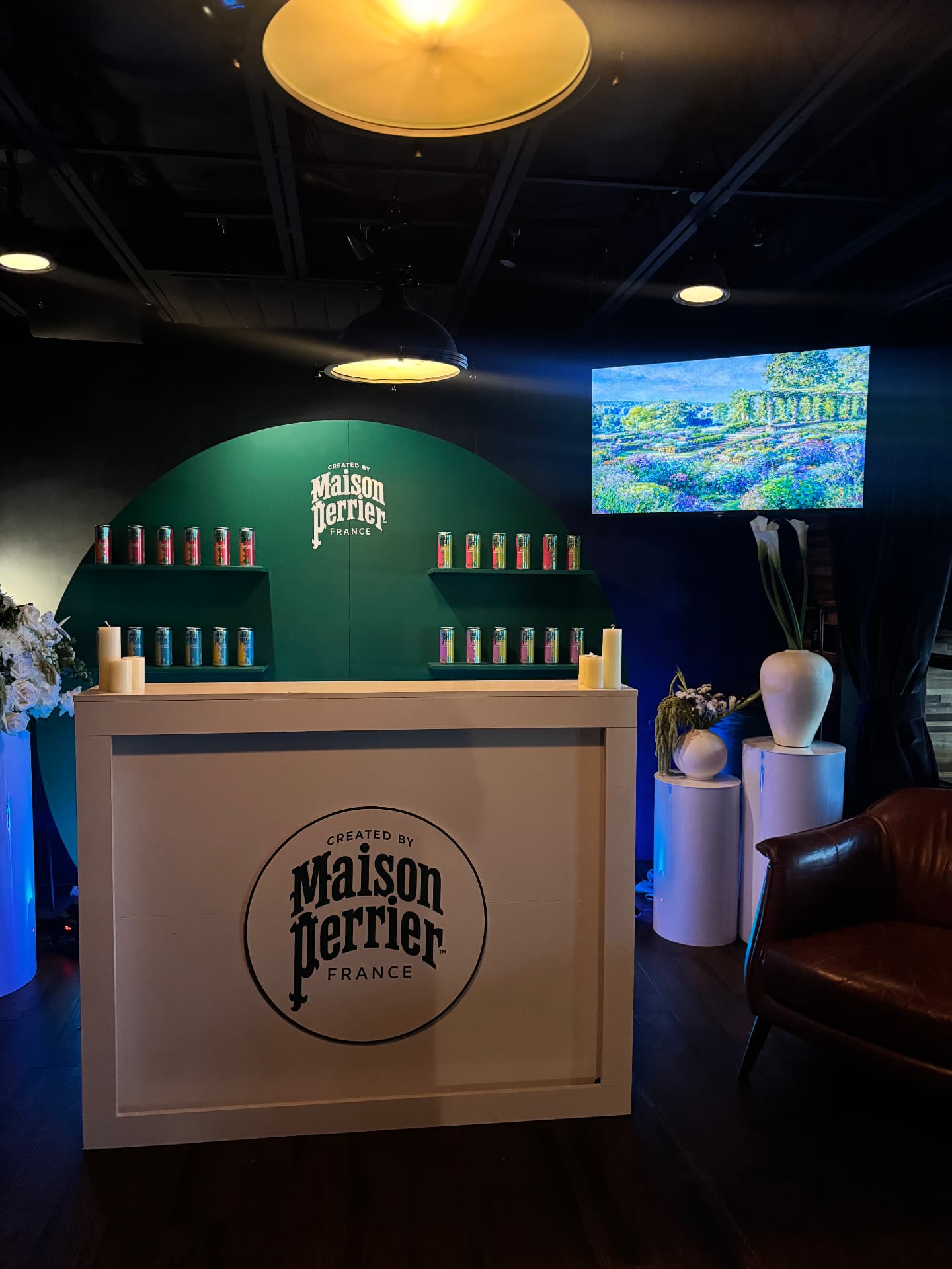 Maison Perrier France branded bar and arched product wall lined with cans